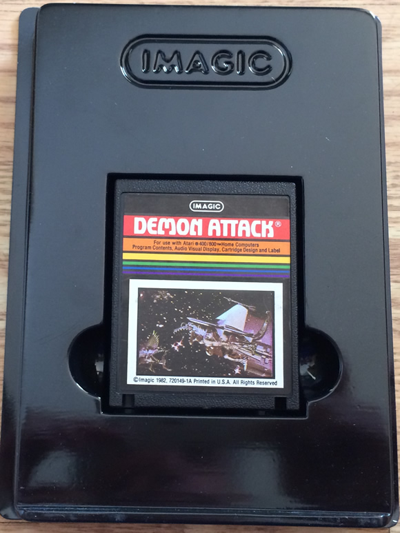 atari_8bit_computer_demon_attack_cart_in_holder